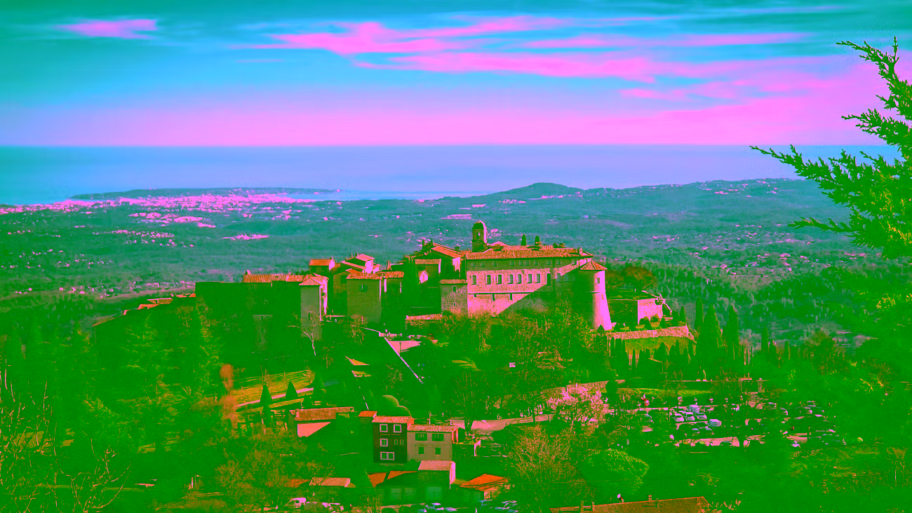Gourdon château and village perched above the Gorges du Loup with the Mediterranean coast stretching to the horizon — shore excursion from Cannes