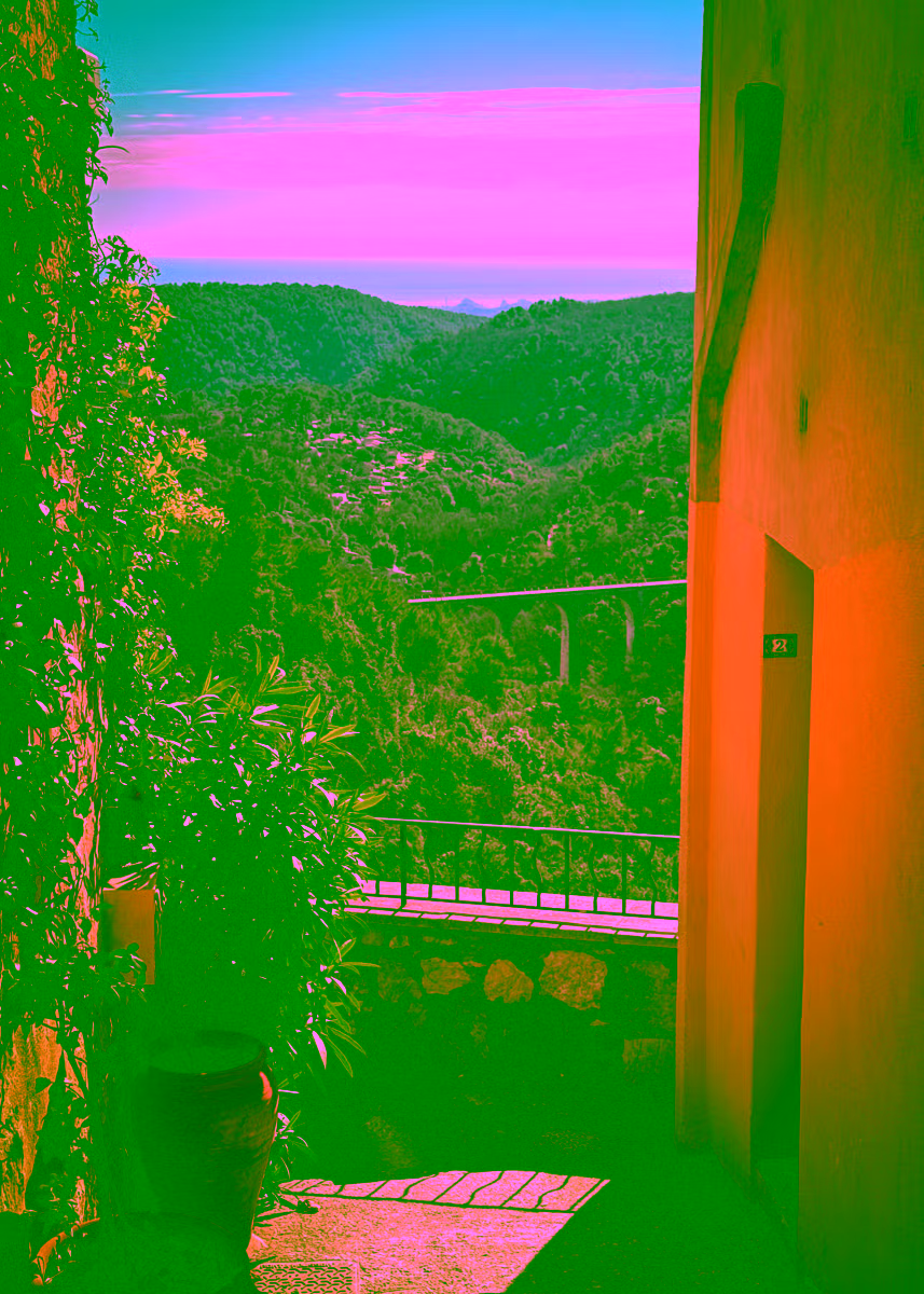 Tourrettes-sur-Loup village lane framing a viaduct and the Mediterranean — shore excursion from Cannes